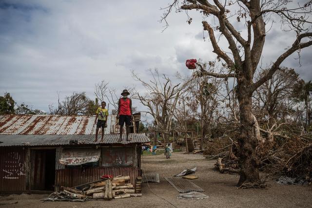 (Foreground) a child and an elderly man stand on the roof of a dwelling damaged Cyclone Pam, on Ifira Island, just off the coast of the main island of Efate. On 25 March 2015 in Vanuatu, 166,000 people remain affected following the destruction caused by Tropical Cyclone Pam, which hit the South Pacific island nation on 13 March. Nearly 60,000 of them are children. The Category 5 storm damaged infrastructure and disrupted key services, putting childrens health, safety and education at risk. Power, water supply and other critical infrastructure have been affected across the archipelago, including in Port Vila, the capital, on Efate Island. Health and other vital services in many areas have also been disrupted, including access to safe drinking water and sanitation facilities, leading to increased risk of water- and vector-borne diseases. Many homes and schools have also been damaged or destroyed. At least 70,000 school-aged children are out of school; and early childhood centres, schools, churches and community halls are serving as evacuation centres and as emergency shelters. Working with the Government and partners, including other United Nations organizations, UNICEF is supporting water, sanitation and hygiene (WASH), health, education, nutrition, protection and other critical services in affected communities. UNICEF, with the World Health Organization (WHO) and the Ministry of Health, is also coordinating a measles-rubella prevention campaign in the country  where immunization rates are low, and which experienced a measles outeak in early March. UNICEF is also supporting communities on Tuvalu and Solomon Island, which have also been affected by Tropical Cyclone Pam.