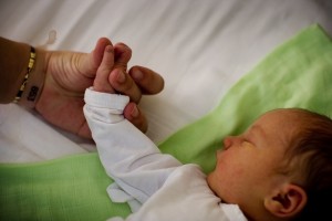 A woman holds the hand of her newborn at the KBC Zvezdara Maternity Hospital in Belgrade, the capital. A UNICEF-supported programme in the hospital teaches women how to care for their newborns, part of an effort to support families and prevent child institutionalization. In June 2011 in Serbia, the proportion of children deprived of parental care is increasing, reflecting trends throughout Central and Eastern Europe and Central Asia. The region has the worlds greatest rate of children growing up in formal alternative care settings, which range from institutionalization to foster care. Some 1.3 million children in the region grow up in formal alternative care, including 626,000 children who live in residential institutions. While rates of child institutionalization in the region have remained stagnant, the overall placement of children in formal care is increasing, often a response to disability or poverty. And in Serbia, child institutionalization rates appear to be increasing, from 349 per 100,000 children in 2004 to 400 per 100,000 children in 2006. Still, Serbia is one of only two countries in the region to approve laws that prohibit the institutionalization of infants (the other is Romania). Institutional care for children under age three is known to be damaging to their mental and emotional development, inhibiting cognitive and speech development, impairing intelligence, and contributing to emotional detachment. Serbia is also one of only four countries in the region to ratify the United Nations Convention on the Rights of Persons with Disabilities. Children with actual or perceived disabilities are at greater risk of being institutionalized and of being abused while in residential care. UNICEF urges Governments throughout Central and Eastern Europe and Central Asia to immediately end the institutionalization of children under age three, to allocate resources to support vulnerable families, to provide alternative services for children with disabilities, and to make the needs and rights of the youngest children a priority in policymaking.