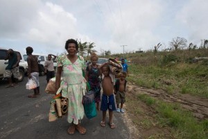 On Sunday 15 March 2015, a family carries their belongings on the outskirts of Port Vila, capital of Vanuatu. Tens of thousands of children are in urgent need of assistance in Vanuatu after tropical Cyclone Pam ripped through the island. The category 5 storm hit late on Friday night, 13 March, and continued into the early hours of Saturday morning, leaving children at particular risk. It is estimated that at least half the population of Vanuatu has been affected by cyclone Pam. Of these, at least 54,000 are children. Many homes in Vanuatu have likely been destroyed as they are built with natural and local materials such as thatched and corrugated roofs that are vulnerable to strong winds and floods. Health centres have likely sustained severe damage and will need rebuilding and restocking with medical and nutrition supplies. Many of these buildings are likely to have suffered structural damage. Lifeline facilities like hospitals, electrical utilities, water supply and telephone systems are most likely severely damaged. Power and water supply has been affected across Vanuatu, including in the capital city Port Vila. Schools are being used as evacuation centres, and UNICEF will be supporting children's education, including providing school in a box kits. Child friendly spaces will be set up in evacuation centres to provide children with psychosocial assistance. Churches and community halls are being used as emergency shelters. Other Pacific Island countries have been severely impact as well, including the Solomon Islands, Tuvalu and Kiribati. UNICEF is on the ground in the affected countries, providing immediate assistance. Most urgent needs include the provision of water containers, purification tablets, soap and temporary sanitation facilities. UNICEF's immediate needs to assist the affected countries is at least US $2 million, initially covering support to water, sanitation, hygiene, health, education, nutrition and protection services, and including support fo