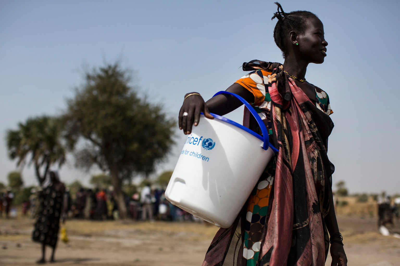 A woman holds a UNICEF donated bucket during a Rapid Response Mission (RRM) in the village of Rubkuai, Unity State, South Sudan, Feuary 16, 2017. In 2017 in South Sudan, ongoing insecurity, combined with an economic crisis that has pushed inflation above 800 percent, has created widespread food insecurity with malnutrition among children having reached emergency levels in most parts of the country. In 2016, UNICEF and partners admitted 184,000 children for treatment of severe malnutrition. That is 50 percent higher than the number treated in 2015 and an increase of 135 percent over 2014. In Feuary 2017, war and a collapsing economy have left some 100,000 people facing starvation in parts of South Sudan where famine was declared 20 Feuary, three UN agencies warned. A further 1 million people are classified as being on the ink of famine. The Food and Agriculture Organization of the United Nations (FAO), the United Nations Children’s Fund (UNICEF) and the World Food Programme (WFP) also warned that urgent action is needed to prevent more people from dying of hunger. If sustained and adequate assistance is delivered urgently, the hunger situation can be improved in the coming months and further suffering mitigated.  The total number of food insecure people is expected to rise to 5.5 million at the height of the lean season in July if nothing is done to curb the severity and spread of the food crisis. According to the Integrated Food Security Phase Classification (IPC) update released 20 Feuary by the government, the three agencies and other humanitarian partners, 4.9 million people – more than 40 percent of South Sudan’s population – are in need of urgent food, agriculture and nutrition assistance. Unimpeded humanitarian access to everyone facing famine, or at risk of famine, is urgently needed to reverse the escalating catastrophe, the UN agencies urged. Further spread of famine can only be prevented if humanitarian assistance is scaled up and